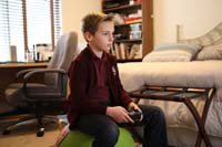 41-Kenny_playing_Lego_video_game_on_Xbox-testing_new_lens_for_SLR