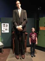 04-Kenny_next_to_real_life_statue_of_tallest_man_in_the_world