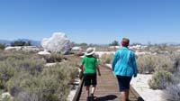 18-Kenny_walking_with_Grammy_on_Longstreet_Boardwalk-rocks_are_some_kind_of_art_perhaps_using_native_rock