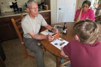 36-Poppy_showing,explaining_to_Kenny_all_his_awards,medals_received_during_his_20_years_in_the_Air_Force