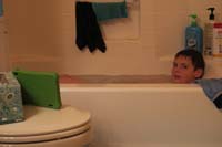 039-spent_a_lot_of_time_in_the_water_for_the_party,now_sits_in_bath_watching_'My_Little_Pony'