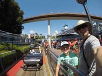 25-Kenny_is_excited_to_ride_the_Autopia_car_driving_experience_with_Daddy-rest_of_group_behind_us