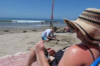 07-Mommy_relaxes_while_Kenny_makes_a_sand_castle