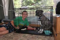 017-Kenny_comforts_Rainier_in_his_crate_since_we_are_leaving_see_sights-afraid_he'll_damage_camper