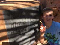 24-lots_of_fun_writing_his_name_using_a_paintbrush_and_water_on_chalkboard_before_it_dries