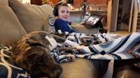 20-Kenny_watches_on_his_tablet_while_his_furbrother_Rainier_lays_next_to_him
