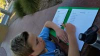 04-doing_homework_at_bus_stop-he_will_be_missing_one_day_of_school