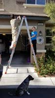09-Kenny_helping_Daddy_put_up_Christmas_lights_on_the_outside_of_the_house