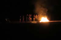 20-group_of_teenagers_light_a_bonfire_.6_miles_SW_of_our_house_in_middle_of_desert,some_jumped_flames