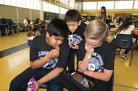 32-Rishi,Christopher,Kenny_hanging_out_watching_a_video_on_Kenny's_tablet