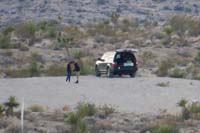 086-behind_our_house-guy_impressing_his_girl_showing_her_how_to_use_a_shotgun_in_the_desert