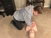 19-Kenny_learns_CPR_while_friend_James_provides_instruction_to_Daddy_at_home_since_visiting