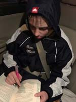 24-Literature_homework_after_swim_practice,busy_kid_getting_homework_done_so_he_can_have_'tablet_time'
