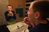 48-Kenny_trying_to_pull_out_his_very_loose_tooth