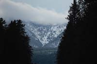 66-fresh_snow_in_distant_mountains_along_dirt_road_drive_to_cold_campsite