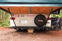 03-couldn't_use_supports,camper_propped_on_piles_of_wood-all_done_with_light_rain