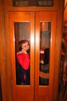 29-Kenny_playfully_uses_a_pay_phone_in_a_phone_booth
