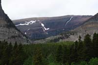 065-scenic_view_at_Apikuni_Falls_trailhead-looks_like_glacial_striations_on_side_of_entire_rock_face