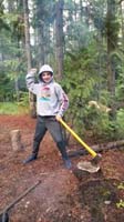 89-Kenny_trying_his_hand_at_chopping_some_wood_using_the_axe