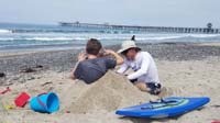 13-Daddy_piles_more_sand_around_Kenny