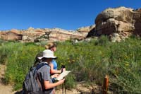 05-Kenny_reads_the_information_from_trailhead_trail_guide_for_interpretive_stop_8