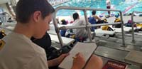 10-Homework_poolside,getting_it_done_when_he_can_and_where_he_can