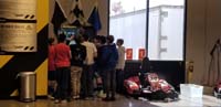 23-Teddy's_birthday_party_at_Pole_Position-kids_crowd_around_watching_a_video_game_being_played