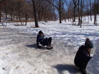 43-kids_scoot_down_the_icy_slope