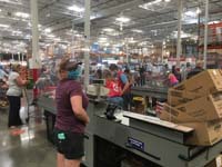 41-checkout_counter_spaced_apart,plastic_barrier_between_cashier_and_member