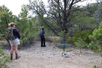06-at_the_junction_for_Mud_Springs_Loop_Trail,someone_added_signage,Kenny_looks_at_bird_feeder
