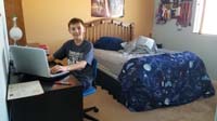 046-Kenny_playing_games_on_his_laptop_in_his_room