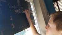 08-Kenny_writes_his_thoughts_on_the_back_of_the_sign-maybe_not_perfect_parenting