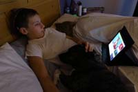 13-Kenny_relaxes_in_bed_watching_videos_on_tablet_and_petting_Rainier,Mommy_sleeps