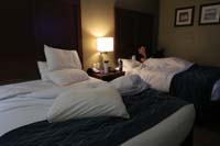 032-hotel_room-relaxing_while_Kenny_watches_a_show_on_his_tablet