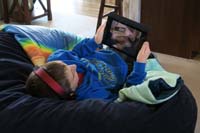 10-Kenny_watching_video_for_school_on_his_tablet_relaxing_on_Benny
