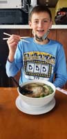 18-Kenny's_going_to_try_to_use_chopsticks-indoor_dining,only_ones_in_restaurant