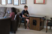 05-teenagers-Nardia_on_her_phone,Kenny_plays_video_games_at_Grandpa_Duke's_house_for_July_4th_party