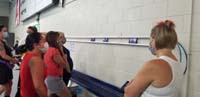 53-Sandpiper_Moms_watching_the_fellow_Sandpiper_swim_in_the_Olympics_on_their_smartphones_during_swim_practice