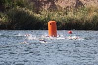 20-Kenny_is_in_green_cap_in_the_middle_rounding_the_corner_for_first_of_two_laps
