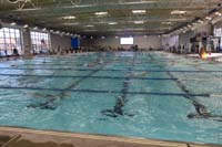 012-pool_now_filled_with_swimmers_swimming_their_warm-up_laps