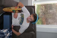 083-Kenny_hangs_out_in_the_family_room_enjoying_a_snack_oblivious_to_the_deer_in_the_yard