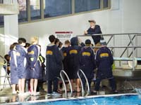 45-Coach_Jake_providing_guidance_to_his_team,Kenny_second_from_right_in_yellow_stripped_knit_hat