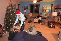 03-Kenny_enjoys_distributing_gifts_for_everyone_to_open,Daddy_came_home_from_work_in_time_to_enjoy_the_activities