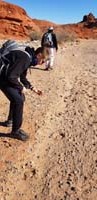 05-Kenny_picking_up_rocks_to_carry_for_the_one-one_rock_for_one_penny_for_Kenny