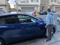 07-Kenny_helping_Mommy_wash_the_Tesla